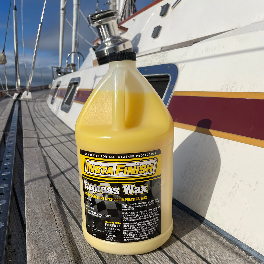 one gallon bottle of Express Wax sitting on the side of a yacht with the mast in the background